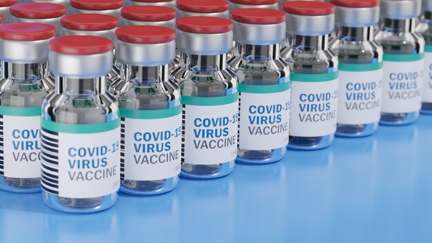 Photo row of covid-19 virus vaccine bottles and  a syringe with a needle on blue surface