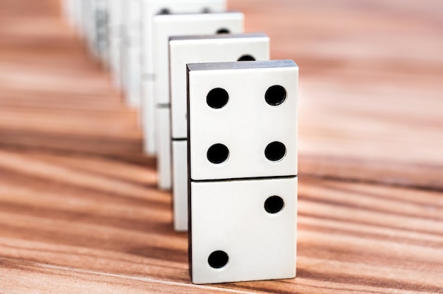 Row of dominoes on the wooden table