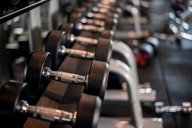 Row of dumbbells in fitness gym