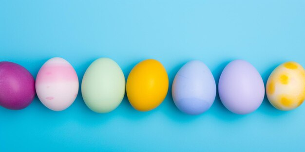 A row of easter eggs with different colors on a blue background.