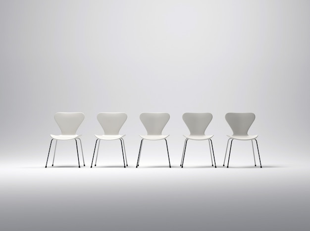 Row of five white plastic and metal chairs in a neutral background