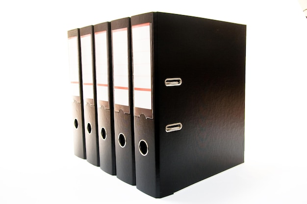 Row of folders for papers and documentation on a shelf in the office