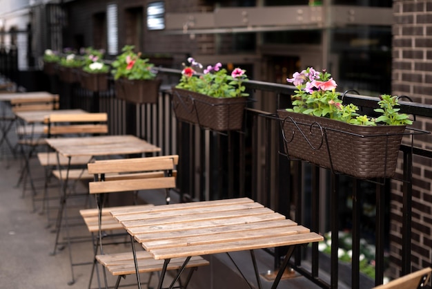 Row of free tables in street outdoor cafe