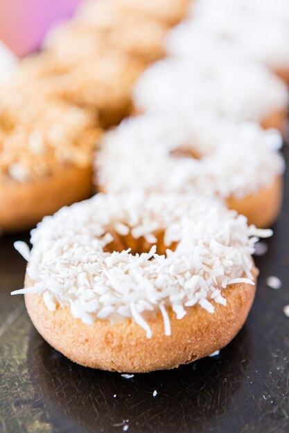 Row of fresh donuts from the local bakery shop.