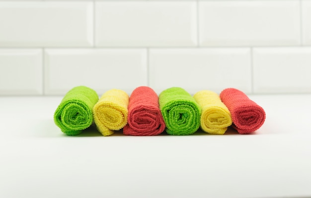 Photo a row of fresh microfibre rags lie on the white table in the kitchen