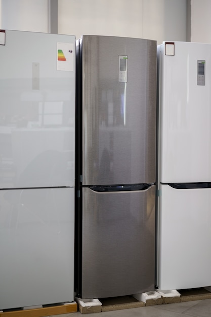 row of fridges in household appliances store