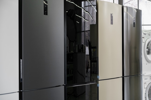row of fridges in household appliances store