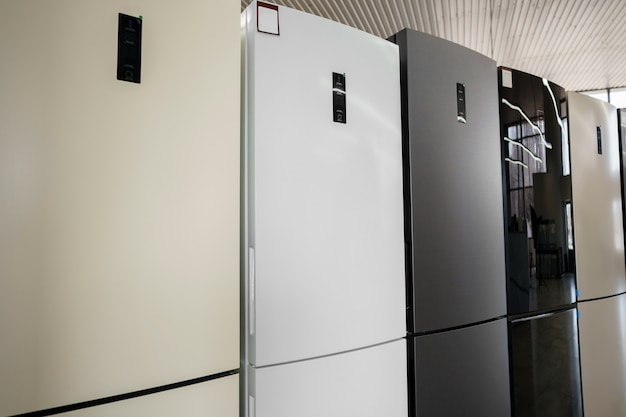 row of fridges in household appliances store