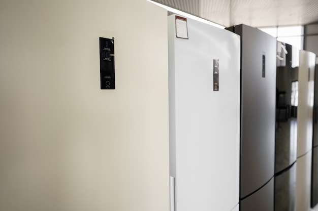 row of fridges in household appliances store