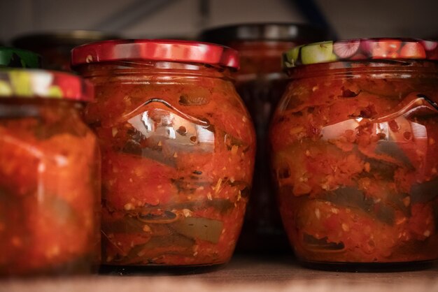 Row of  glass jars with marinated or fermented food