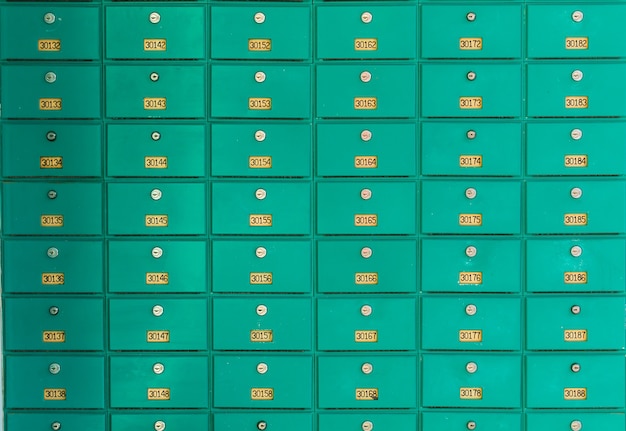 A row of green mailboxs. Post office