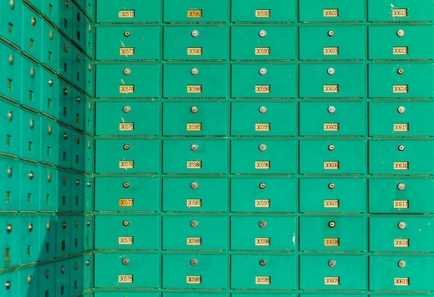 A row of green mailboxs. Post office