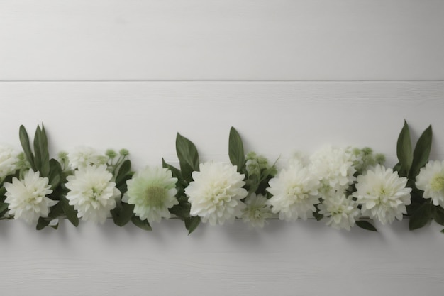 A row of green and white flowers against a white wall