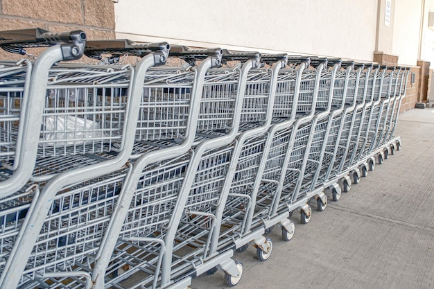 A row of grocery shopping carts at a supermarket