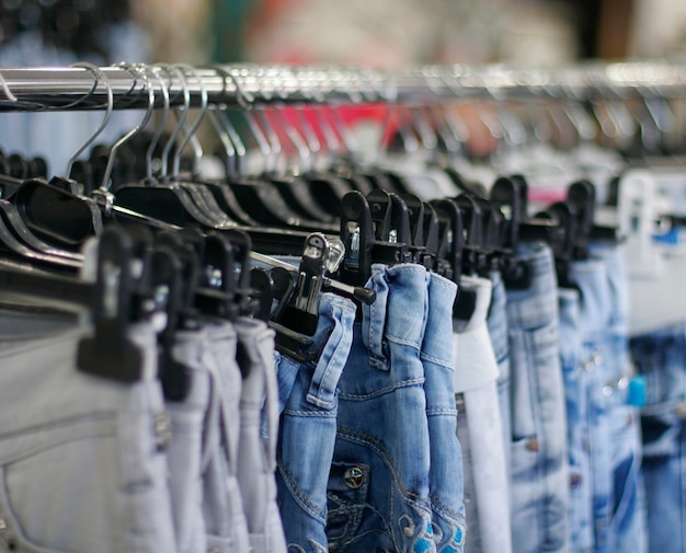 Row of hanged blue jeans in a shop