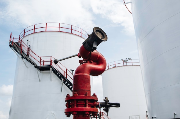 Row of large white tanks for petrol pipeline fire water oil and gas