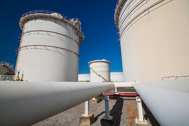 Row of large white tanks for petrol pipeline oil and gas