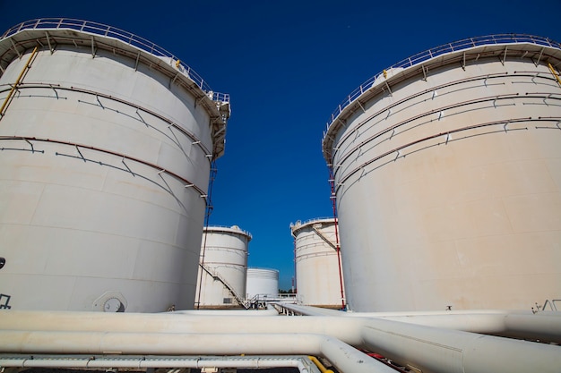 Row of large white tanks for petrol pipeline oil and gas