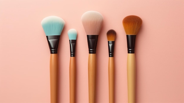 A row of makeup brushes on a pink background