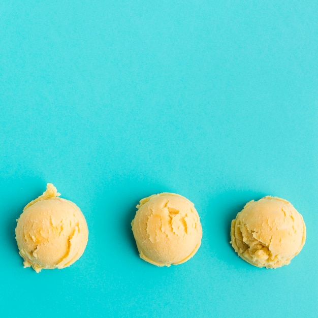 Row of mango ice cream scoops