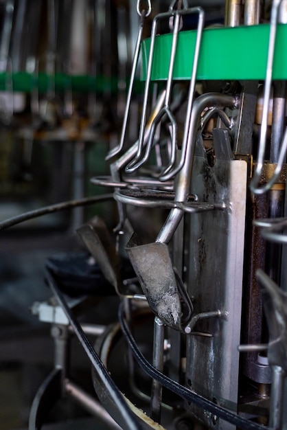 A row of metal utensils with a green light above them.