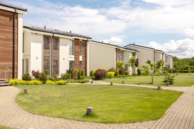 Row of modern cottages Brand new row of single family houses Modern design of urban living residences with private courtyards sophisticated finishes new development Green outdoor facilities lawn