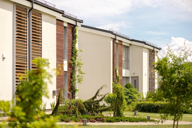 row of modern cottages brand new row of single family houses modern design of urban living residences with private courtyards sophisticated finishes new development green outdoor facilities lawn