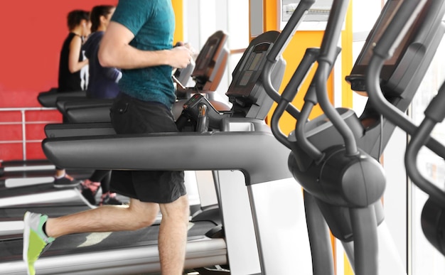 Row of modern treadmills in gym