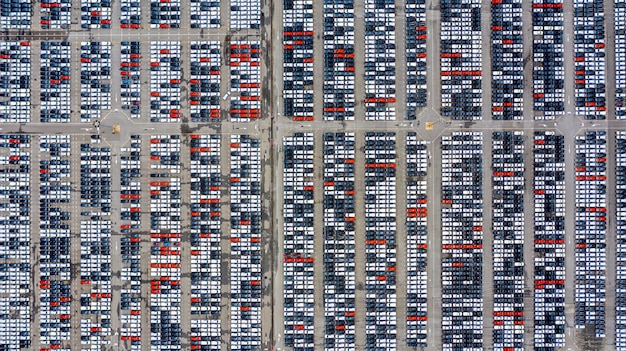 Row of new cars for sale in port at cars export terminal.