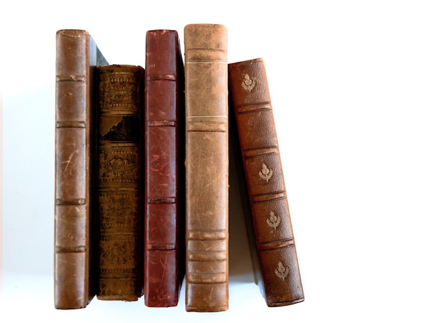 Row of old books isolated on white background