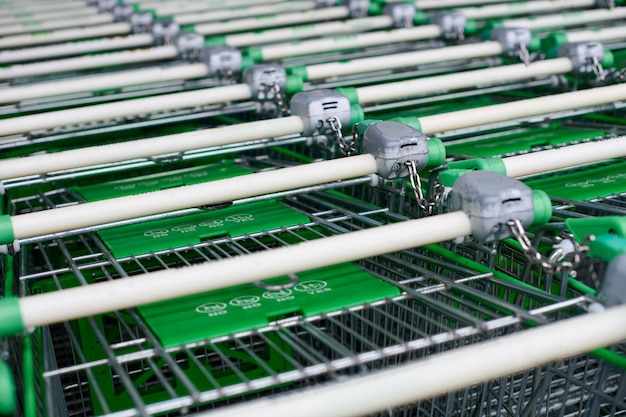 Row of parked trolleys in supermarket