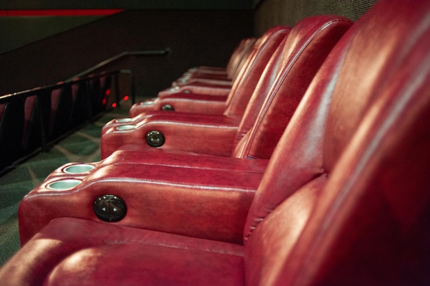 A row of red chairs with black buttons