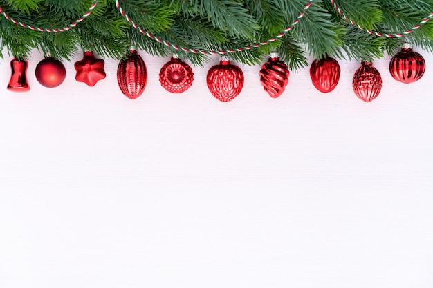 A Row of Red Christmas Baubles on fir branches