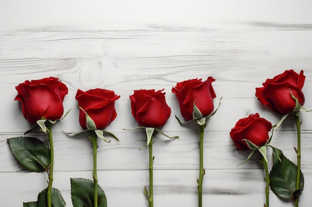 A row of red roses on a wooden table