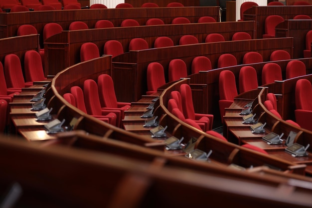 A row of red seats in a large auditorium with red seats