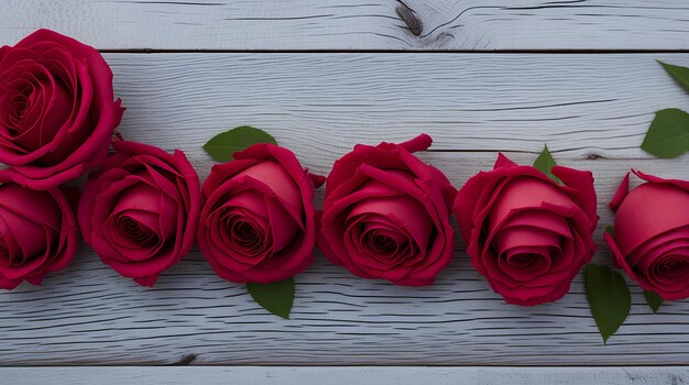 A row of roses on a wooden table