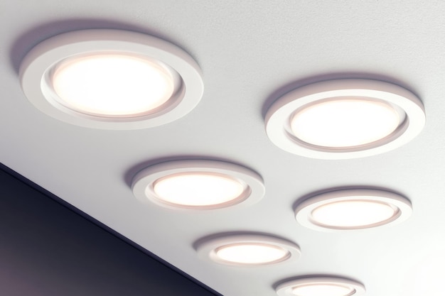 a row of round lights on a ceiling that is white