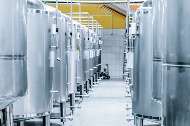 Row of steel tanks for storage and fermentation of beer. Toning the image.