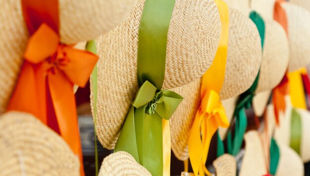 Row of straw hats with ribbons