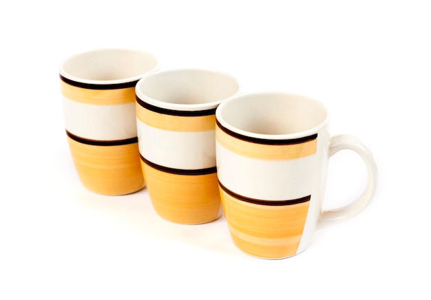 Row of three mugs isolated on white background