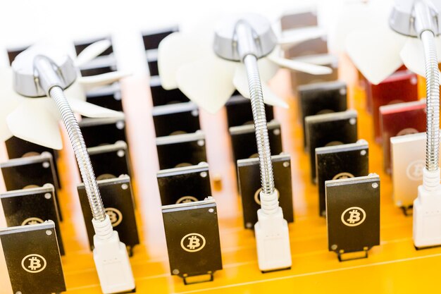 Row of USB bitcoin miners plugged into large USB board.