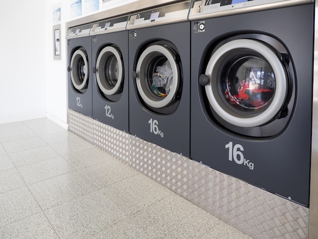 Row of washing machines in a public laundromat. Cleaning concept