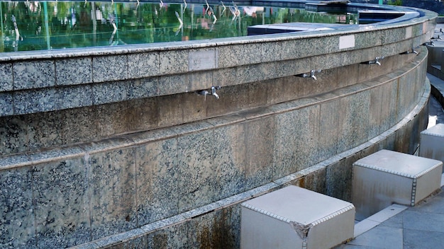 a row of water faucets for ablution wudhu Cleansing room Place to wash hands do ablution wudhu