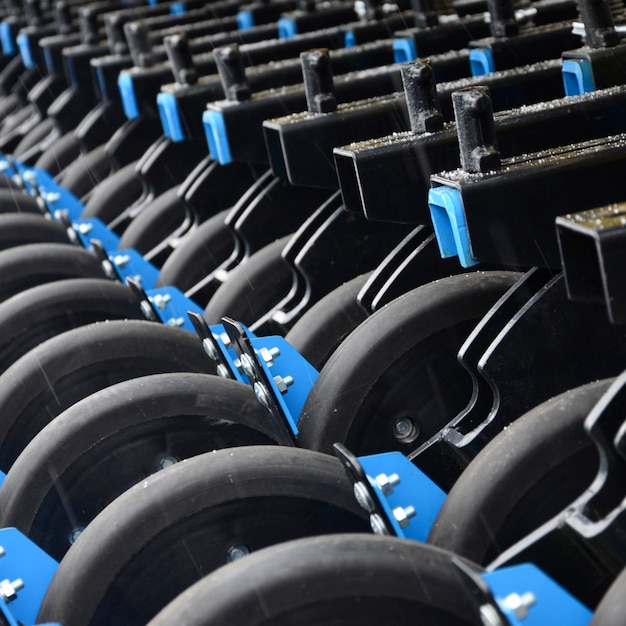 Row of wheels of the new industrial agricultural seeder close up