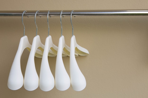 row of white cloth hangers