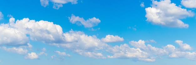 Row of white clouds in the blue sky, panorama