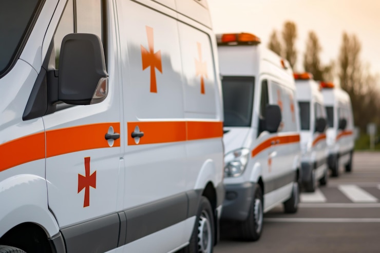 Photo row of white and orange ambulances parked representing emergency medical services at dusk