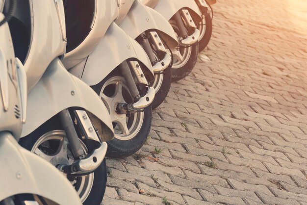 Row of white scooter on the sidewalk