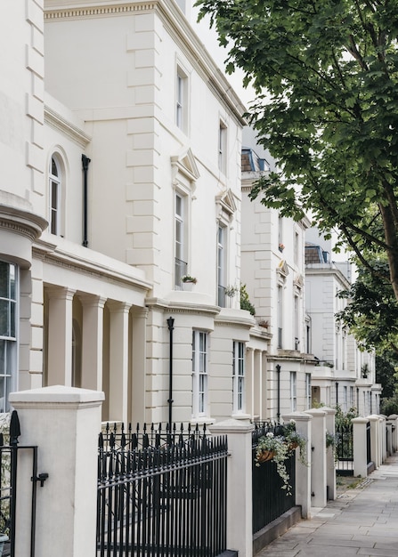 Row of white terraced houses on a street in london uk in summer