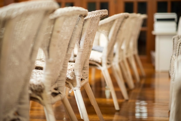 Row of white wedding chairs 